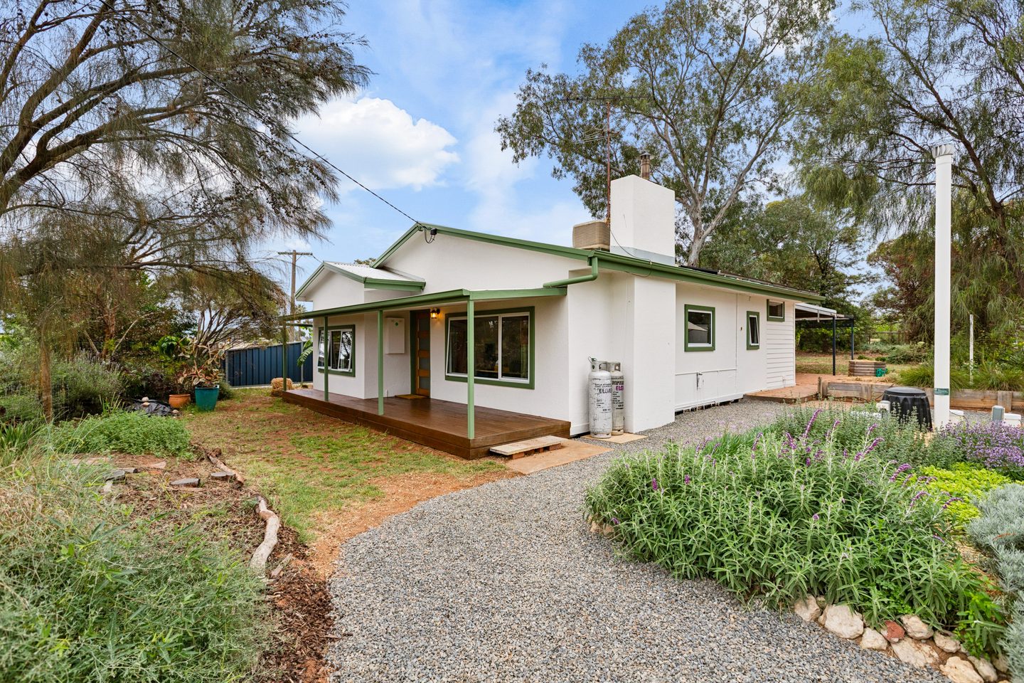 The green-trimmed home at 997 Irymple Avenue, with its front verandah and garden