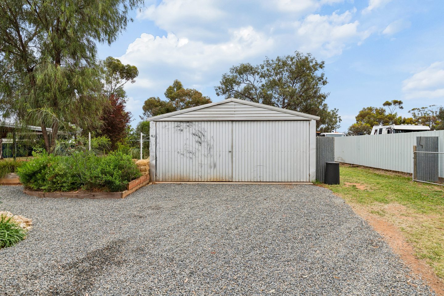 The shed with its wide gravel approach and surrounding garden